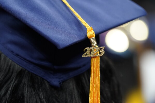 FILE - A tassel with 2023 on it rests on a graduation cap as students walk in a procession for Howard University's commencement in Washington, Saturday, May 13, 2023. A federal appeals court says a Biden administration plan to provide student debt relief for people who say they were victims of misleading information by trade schools or colleges is “almost certainly unlawful.” The 5th U.S. Circuit Court of Appeals ruling, dated Thursday, April 4, 2024, came in a court challenge filed by Career Colleges and Schools of Texas. (AP Photo/Alex Brandon, File)