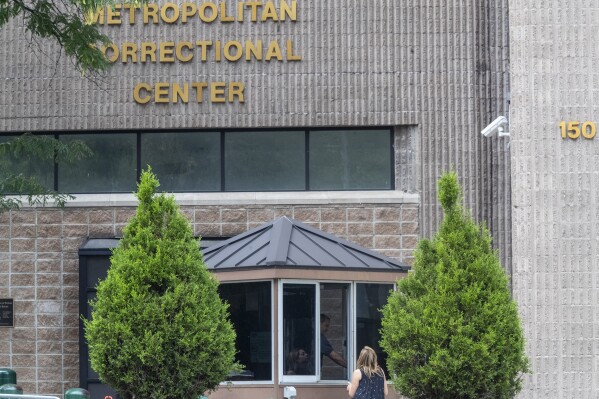 FILE - In this Aug. 13, 2019 file photo, an employee checks a visitor outside the Metropolitan Correctional Center in New York. The Justice Department’s watchdog said Tuesday that “a combination of negligence and misconduct” enabled Jeffrey Epstein to take his own life at a federal jail in New York City. (AP Photo/Mary Altaffer, File)
