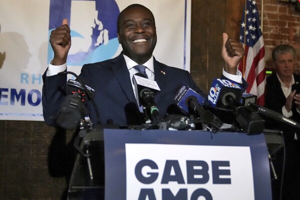 Democrat Gabe Amo gives both thumbs up to the room full of election night supporters, Tuesday, Nov. 7, 2023, at The Guild in Pawtucket, R.I., after winning Rhode Island’s 1st Congressional District seat. The former White House aide will become the state’s first Black candidate elected to the U.S. House. (Kris Craig/Providence Journal via AP)