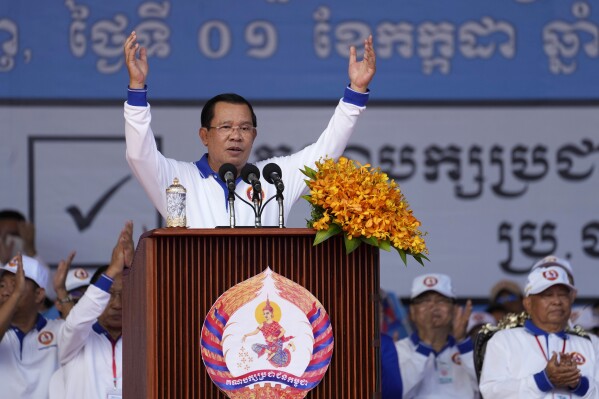 FILE - Cambodia Prime Minister Hun Sen, center, also President of Cambodian People's Party, delivers a speech during his party election campaign in Phnom Penh Cambodia, Saturday, July 1, 2023. Two senior members of Cambodia’s opposition Candlelight Party have been arrested for allegedly teaching voters how to cast a null ballot in this month's general election, becoming the first people to be arrested under the country's recently amended election law. (AP Photo/Heng Sinith, File)