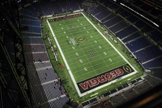 Fans begin to fill the stands at at Lucas Oil Stadium before the College Football Playoff championship football game between Alabama and Georgia Monday, Jan. 10, 2022, in Indianapolis. (AP Photo/Charlie Riedel)