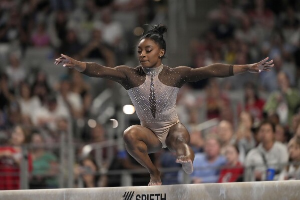 Simone Biles competes on the balance beam during the U.S. Gymnastics Championships, Sunday, June 2, 2024, in Fort Worth, Texas. (AP Photo/Julio Cortez)