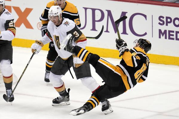 Pittsburgh Penguins' Sidney Crosby (87) is checked off his skates by Vegas Golden Knights' Brayden McNabb (3) during the third period of an NHL hockey game in Pittsburgh, Thursday, Dec. 1, 2022. (AP Photo/Gene J. Puskar)