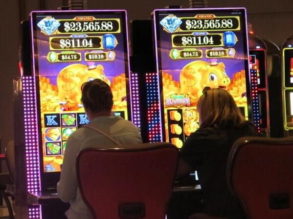 Gamblers play at the slot machines at the Hard Rock casino, June 28, 2021, in Atlantic City, N.J. On Jan. 14, 2022, New Jersey regulators released figures showing the state's casinos and horse tracks that accept sports bets won over $4.7 billion in 2021; $2.5 billion of that came from gamblers physically present at casinos, down slightly from the level of in-person gambling revenue in 2019, before the coronavirus pandemic hit. (AP Photo/Wayne Parry)