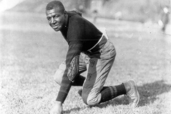 Iowa football player Frederick "Duke" Slater poses for a photo in 1921  Slater was the NFL’s first African-American lineman, and often the only Black player on the field. After retiring, he broke down more racial barriers to become a judge in Chicago. (Chicago Sun-Times via AP)