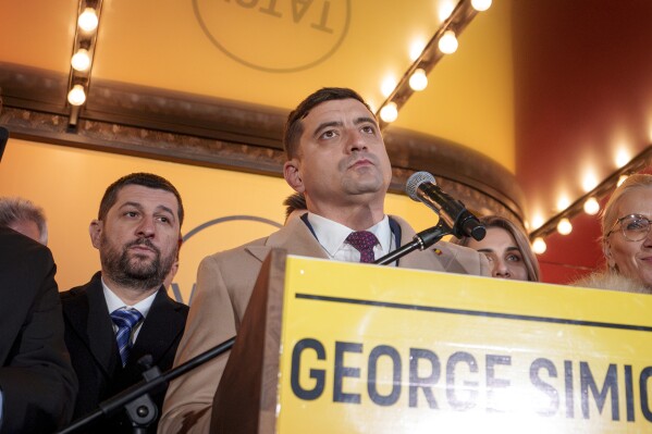 George Simion, the Alliance for the Unity of Romanians (AUR) candidate for president speaks to media after polls closed during the country's presidential elections, in Bucharest, Romania, Sunday, Nov. 24, 2024. (AP Photo/Andreea Alexandru)