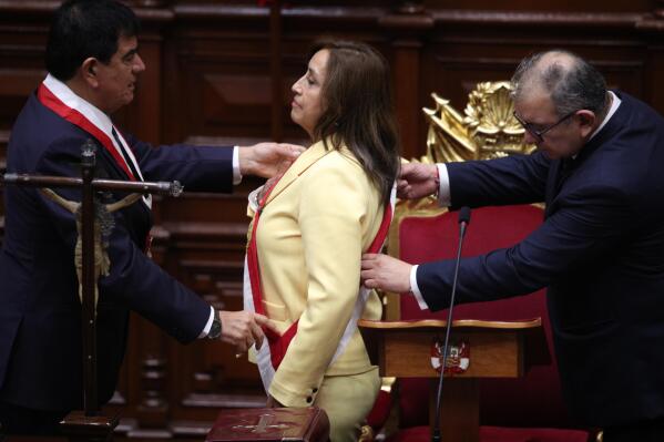 Former Vice President Dina Boluarte receives the presidential sash as she is sworn-in as the new president at Congress in Lima, Peru, Wednesday, Dec. 7, 2022. Peru's Congress voted to removePresident Pedro Castillofrom office Wednesday and replace him with the vice president, shortly after Castillo tried to dissolve the legislature ahead of a scheduled vote to remove him. At left is Congress President Jose Williams and at right is Jose Cevasco. (AP Photo/Guadalupe Pardo)
