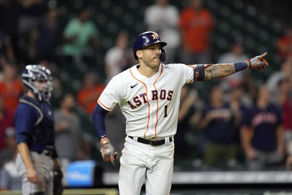 Houston Astros' Carlos Correa (1) celebrates after hitting a game-winning RBI ground-rule double against the Seattle Mariners during the 10th inning of a baseball game Tuesday, Sept. 7, 2021, in Houston. The Astros won 5-4 in 10 innings. (AP Photo/David J. Phillip)