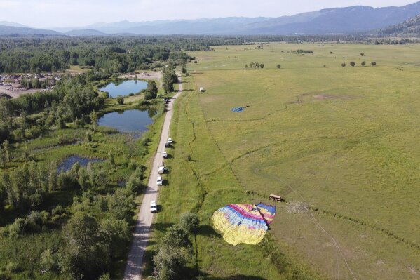 Two of three sightseeing balloons that crashed Monday, Aug. 3, 2020, are seen in an open area of Jackson Hole in western Wyoming. Between 16 and 20 people were hurt, officials said. (Brad Boner/Jackson Hole News&Guide via AP)