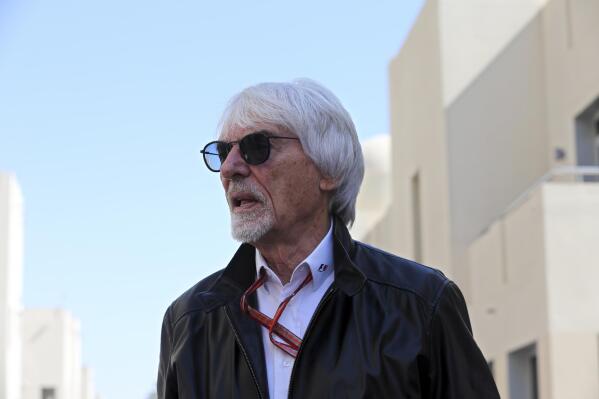 FILE -  Former Formula One boss Bernie Ecclestone walks in the paddock during the first free practice at the Yas Marina racetrack in Abu Dhabi, United Arab Emirates, Friday Nov. 23, 2018. British prosecutors say former Formula One boss Bernie Ecclestone will be charged with fraud by false representation following a government investigation into his overseas assets. (AP Photo/Kamran Jebreili, File)