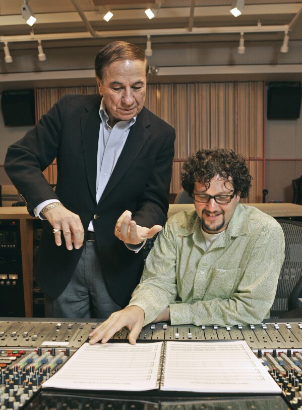 FILE - Composers Richard M. Sherman, left, who, along with his brother Robert, wrote the song 