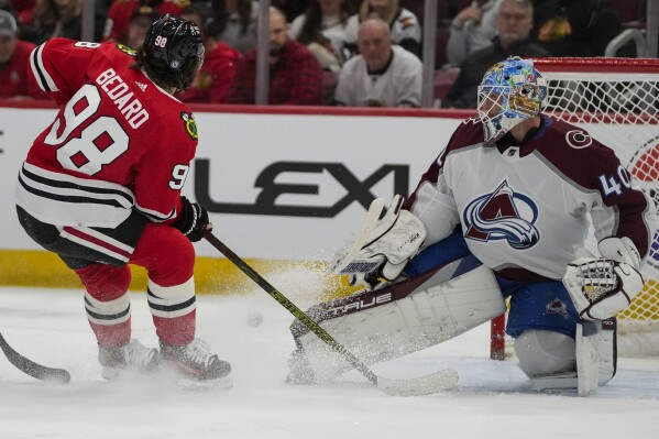 Colorado Avalanche goaltender Alexandar Georgiev stops a shot from Chicago Blackhawks center Connor Bedard during the second period of an NHL hockey game Tuesday, Dec. 19, 2023, in Chicago. (AP Photo/Erin Hooley)