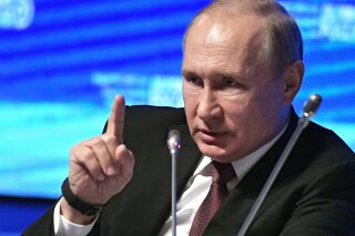 Russian President Vladimir Putin makes a point as he speaks at the plenary session of the Business Russia forum in Moscow, Russia, Wednesday, Feb. 6, 2019. (Alexei Nikolsky, Sputnik, Kremlin Pool Photo via AP)