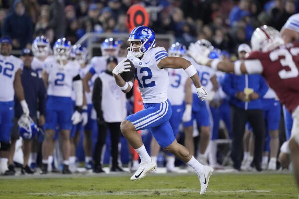BYU wide receiver Puka Nacua (12) runs the ball for a touchdown against Stanford during the second half of an NCAA college football game in Stanford, Calif., Saturday, Nov. 26, 2022. (AP Photo/Godofredo A. Vásquez)
