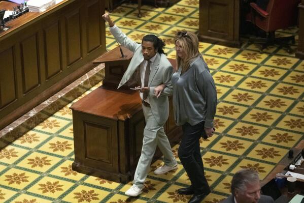 Rep. Justin Jones, D-Nashville, walks into the House chamber with Rep. Gloria Johnson, D-Knoxville, Monday, April 10, 2023, in Nashville, Tenn. Jones was appointed to represent District 52 by the Metro Nashville City Council earlier in the day after being expelled the previous week for using a bullhorn to shout support for pro-gun control protesters in the House chamber. (AP Photo/George Walker IV)