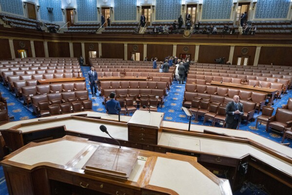 President Joe Biden, back center, departs a nearly empty House chamber after delivering the State of the Union address to a joint session of Congress at the U.S. Capitol, Thursday March 7, 2024, in Washington. (AP Photo/Alex Brandon, Pool)