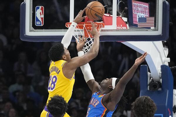 Los Angeles Lakers forward Rui Hachimura (28) is fouled by Oklahoma City Thunder guard Luguentz Dort (5) as he shoots in the first half of an NBA basketball game Wednesday, March 1, 2023, in Oklahoma City. (AP Photo/Sue Ogrocki)