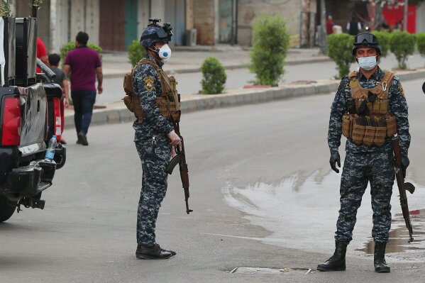 Security forces are deployed to enforce a curfew to help fight the spread of the coronavirus. in central Baghdad, Iraq, Tuesday, March 31, 2020. The new coronavirus causes mild or moderate symptoms for most people, but for some, especially older adults and people with existing health problems, it can cause more severe illness or death. (AP Photo/Hadi Mizban)