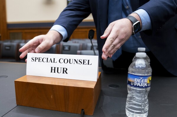 Staff place a name placard for Special Counsel Robert Hur ahead of a hearing of the House Judiciary Committee in the Rayburn House Office Building on Capitol Hill in Washington, Tuesday, March 12, 2024. (AP Photo/Nathan Howard)