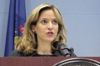 FILE - In this March 5, 2020, file photo, Michigan Secretary of State Jocelyn Benson speaks at a news conference in Lansing, Mich. Michigan's top election official said Tuesday, May, 19, 2020, that absentee ballot applications will be mailed to all 7.7 million registered voters for the August primary and November general election. Benson said the step — announced as the state continues to confront the coronavirus pandemic — ensures no one "has to to choose between their health and their right to vote." (AP Photo/David Eggert, File)