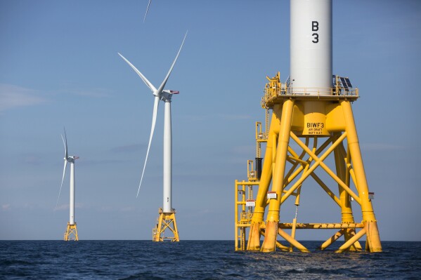 FILE - Three wind turbines from Deepwater Wind stand in the water off Block Island, R.I, the nation's first offshore wind farm, Aug. 15, 2016. Another planned offshore wind farm, by Revolution Wind, moved a step closer to construction on Tuesday, Aug. 22, 2023, with the Department of the Interior announcing it has approved the project, to be located in federal waters about 15 miles southeast of Point Judith, R.I, and south of Martha's Vineyard, Mass. (AP Photo/Michael Dwyer, File)