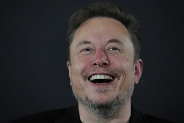 File - Elon Musk laughes during an event with Britain's Prime Minister Rishi Sunak in London, Nov. 2, 2023. A little more than a year ago, billionaire and new owner Musk walked into Twitter's San Francisco headquarters, fired its CEO and other top executives and began transforming the social media platform into what is now known as X. (AP Photo/Kirsty Wigglesworth, Pool, File)