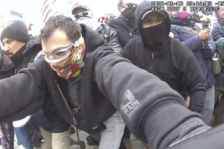 This image from police body-worn camera video, and contained in the Justice Department's sentencing memorandum, shows Marc Bru, at the U.S. Capitol on Jan. 6, 2021, in Washington. Bru, who stormed the U.S. Capitol with fellow Proud Boys extremist group members, has been sentenced to six years in prison. (Department of Justice via AP)