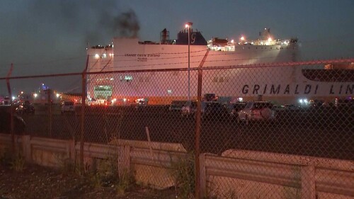 In this image taken from video, smoke rises from a cargo ship early Thursday, July 6, 2023, in the port of Newark, New Jersey. Two firefighters were killed battling the blaze that began when cars caught fire deep inside the ship carrying 5,000 cars at the port, Newark's fire chief said. (WABC-TV via AP)
