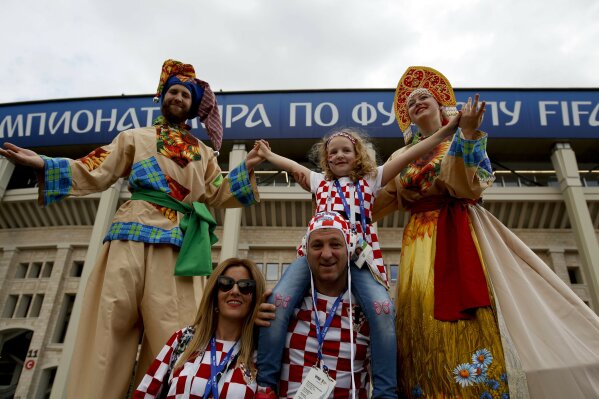 
              Croatia fans pose for a picture before the semifinal match between Croatia and England at the 2018 soccer World Cup in the Luzhniki Stadium in Moscow, Russia, Wednesday, July 11, 2018. (AP Photo/Rebecca Blackwell)
            