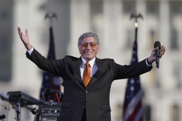 FILE - Singer Tony Bennett reacts to the crowd during his performance at comedians Jon Stewart's and Stephen Colbert's Rally to Restore Sanity and/or Fear on the National Mall in Washington, Saturday, Oct. 30, 2010. Bennett, the eminent and timeless stylist whose devotion to classic American songs and knack for creating new standards such as "I Left My Heart In San Francisco" graced a decadeslong career that brought him admirers from Frank Sinatra to Lady Gaga, died Friday, July 21, 2023. He was 96. (AP Photo/Carolyn Kaster, File)