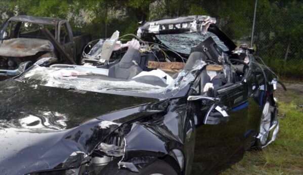 FILE - In this photo provided by the National Transportation Safety Board via the Florida Highway Patrol, a Tesla Model S that was being driven by Joshua Brown, who was killed when the Tesla sedan crashed while in self-driving mode on May 7, 2016. (NTSB via Florida Highway Patrol via AP, File)