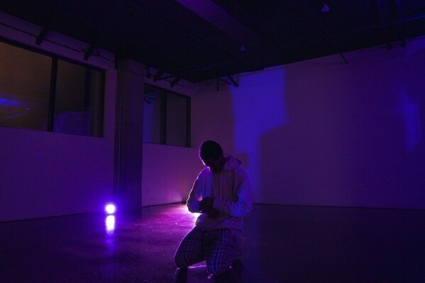 DeSean Aaron, 19, kneels in prayer after a night of dancing at The Cove, an 18-and-up, pop-up Christian nightclub, on Saturday, Feb. 17, 2024, in Nashville, Tenn. (AP Photo/Jessie Wardarski)