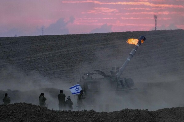 An Israeli mobile artillery unit fired a shell from southern Israel towards the Gaza Strip, in a position near the Israel-Gaza border, Israel, Saturday, Oct. 14, 2023. (AP Photo/Maya Allerruzzo)