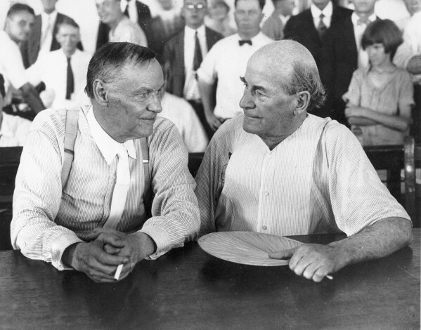 Defense attorney Clarence Darrow, left, and prosecutor William Jennings Bryan speak with each other during the Scopes monkey trial in July 1925, in Dayton, Tenn. (AP Photo, File)