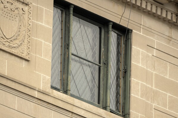 Wires are seen leading from a top floor corner window to the roof of the headquarters of the General Services Administration (GSA) Wednesday, April 2, 2025, in Washington. (AP Photo/Mark Schiefelbein)