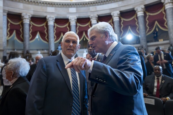 Former Vice President Mike Pence speaks with Rev. Franklin Graham, son of the late Rev. Billy Graham, at a statue unveiling ceremony at the U.S. Capitol in Washington, where it will stand on behalf of his native North Carolina, Thursday, May 16, 2024. Known as America's pastor, Graham died in 2018 at age 99. (AP Photo/J. Scott Applewhite)