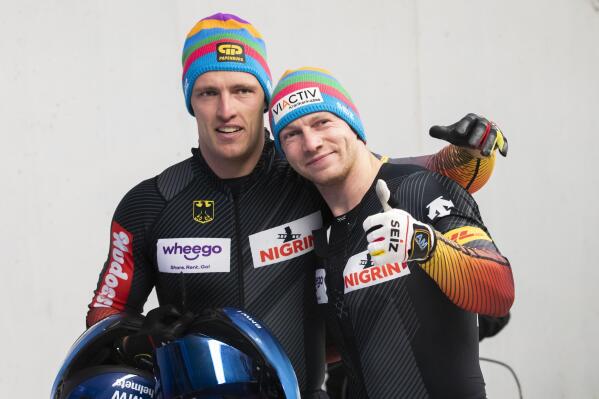 The winners Francesco Friedrich and Thorsten Margis from Germany pose for a photo after the 2-man bobsleigh World Cup race in Igls, near Innsbruck, Austria, Saturday, Nov. 27, 2021. (AP Photo/Lisa Leutner)