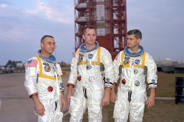 In this undated photo made available by NASA, from left, veteran astronaut Virgil Grissom, first American spacewalker Ed White and rookie Roger Chaffee, stand for a photograph in Cape Kennedy, Fla. During a launch pad test on Jan. 27, 1967, a flash fire erupted inside their capsule killing the three Apollo crew members. (NASA via AP)