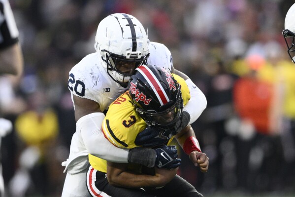 Penn State defensive end Adisa Isaac (20) sacks Maryland quarterback Taulia Tagovailoa (3) during the second half of an NCAA college football game, Saturday, Nov. 4, 2023, in College Park, Md. (AP Photo/Nick Wass)