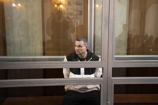 U.S. Army Staff Sgt. Gordon Black sits in a glass cage in courtroom in Vladivostok, Russia, Thursday, June 6, 2024. A court in Russia's far eastern city of Vladivostok on Thursday began the trial of an American soldier arrested in the city earlier this year on charges of stealing. He faces up to five years in prison if convicted. (AP Photo/)
