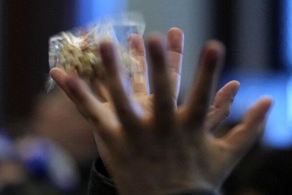 A participant catches lucky beans dispersed by celebrities during the 