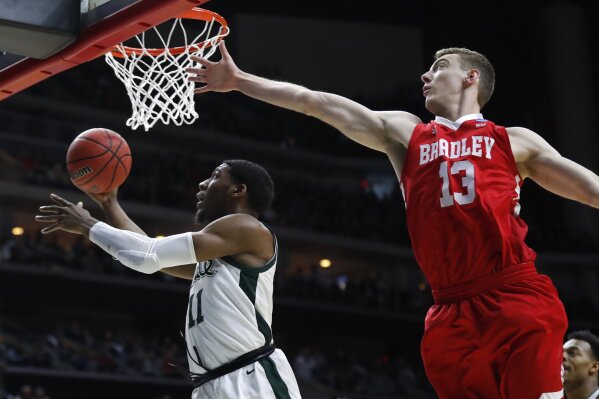 
              Michigan State forward Aaron Henry drives to the basket past Bradley forward Luuk van Bree, right, during a first round men's college basketball game in the NCAA Tournament, Thursday, March 21, 2019, in Des Moines, Iowa. (AP Photo/Charlie Neibergall)
            