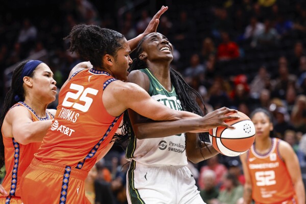 Seattle Storm's Ezi Magbegor is fouled Connecticut Sun's Alyssa Thomas (25) during the first half of a WNBA basketball game Tuesday, June 20, 2023, in Seattle. (Dean Rutz/The Seattle Times via AP)
