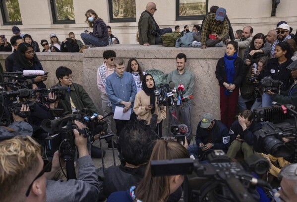 Mahmoud Khalil, center right, listens as members of the student protest negotiation team speak during a press conference near the pro-Palestinian demonstration encampment at the Columbia University, Friday, April 26, 2024, in New York. (AP Photo/Yuki Iwamura, File)