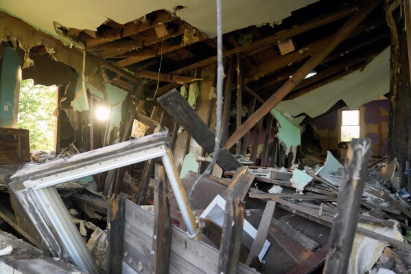 The interior of a flood-damaged home is visible on Wednesday, May 22, 2024, in West Alton, Mo. Data from First Street shows that while West Alton is an extreme example of flooding's effect, it's emblematic of challenges faced by smaller communities in the Midwest and South. (AP Photo/Jeff Roberson)