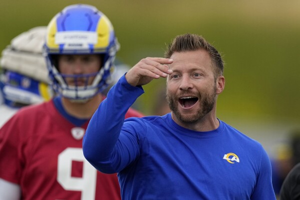 FILE - Los Angeles Rams head coach Sean McVay, right, gestures as quarterback Matthew Stafford stands in the background during the NFL football team's organized activities Wednesday, May 31, 2023, in Thousand Oaks, Calif. They gutted their roster and made no major free agent additions, electing to play this season with an unimpressive supporting cast around Aaron Donald, Matthew Stafford and Cooper Kupp. At least coach Sean McVay seems focused and happy after flirting with retirement for the past two offseasons, and he has plenty of work to do. (AP Photo/Mark J. Terrill, File)