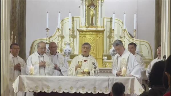 In this image taken from video footage run by TVB, Hong Kong Bishop Stephen Chow, center, takes part in mass at the Wangfujing Church in Beijing, Friday, April 21, 2023. Hong Kong's Roman Catholic bishop on Friday said he had invited a leader of the Communist Party-controlled group for Catholics in mainland China to visit his city, in a high-profile gesture aimed at improving strained Vatican relations with Beijing. (TVB via AP)