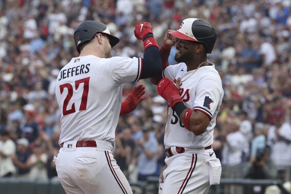 Minnesota Twins' Ryan Jeffers (27) celebrates with Willi Castro (50) after hitting a home run during the second inning of a baseball game against the Arizona Diamondbacks, Saturday, Aug. 5, 2023, in Minneapolis. (AP Photo/Stacy Bengs)