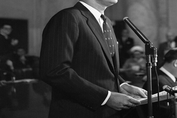 FILE - In this Jan. 2, 1960, file photo, Sen. John F. Kennedy, D-Mass., formally announces at a news conference in Washington that he is a candidate for the Democratic presidential nomination. A handwritten draft Kennedy's announcement speech is among hundreds of items associated with the late president to be auctioned in January 2020, by the Boston-based RR Auction. Online bidding for the collection put together by a California man opens Jan. 17. (AP Photo, File)