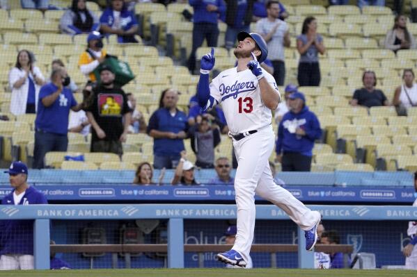 Los Angeles Dodgers' Max Muncy gestures before scoring after hitting a two-run home run during the first inning of a baseball game against the Texas Rangers Friday, June 11, 2021, in Los Angeles. (AP Photo/Mark J. Terrill)